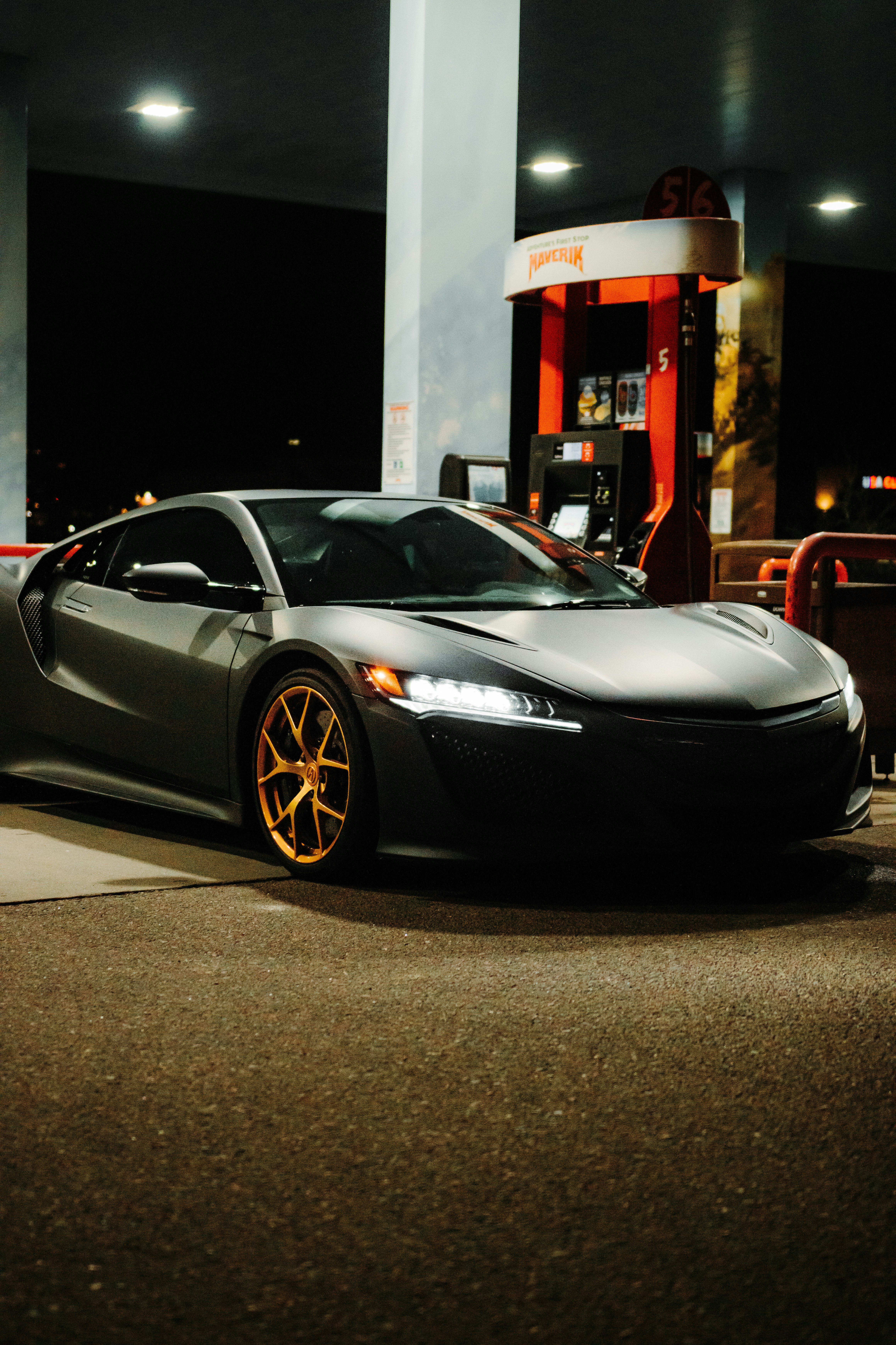 black porsche 911 parked in front of store